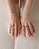 11:11 engraved gold ring styled with multiple rings and a gold hand chain.