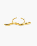 Polished gold-tone Amelia open ring with an elongated sculptural wave bar on a white background.