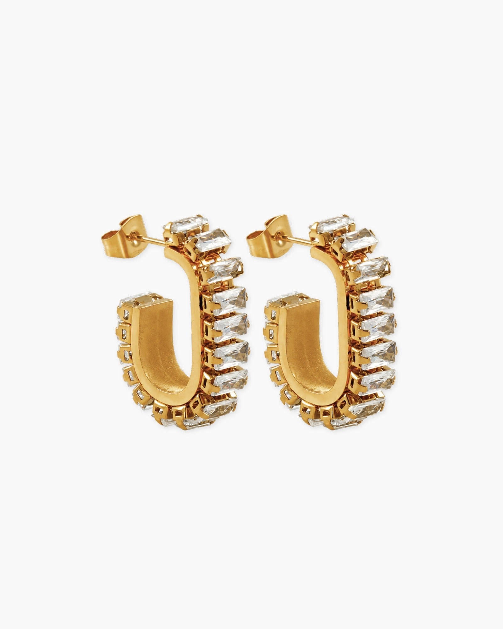 Pair of gold-tone elongated statement hoops lined with clear baguette-cut stones.
