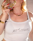 Model wearing the white Need Money for Martinis cami tank while holding a martini glass.