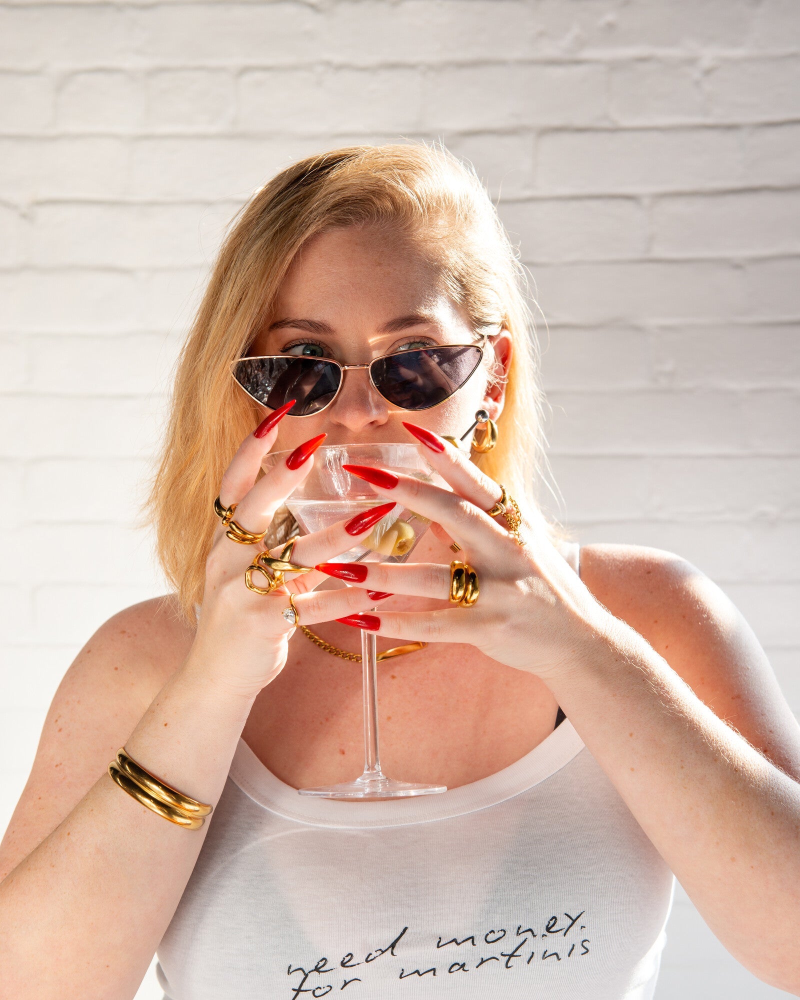 Model wearing the white Need Money for Martinis cami tank in a close lifestyle portrait.
