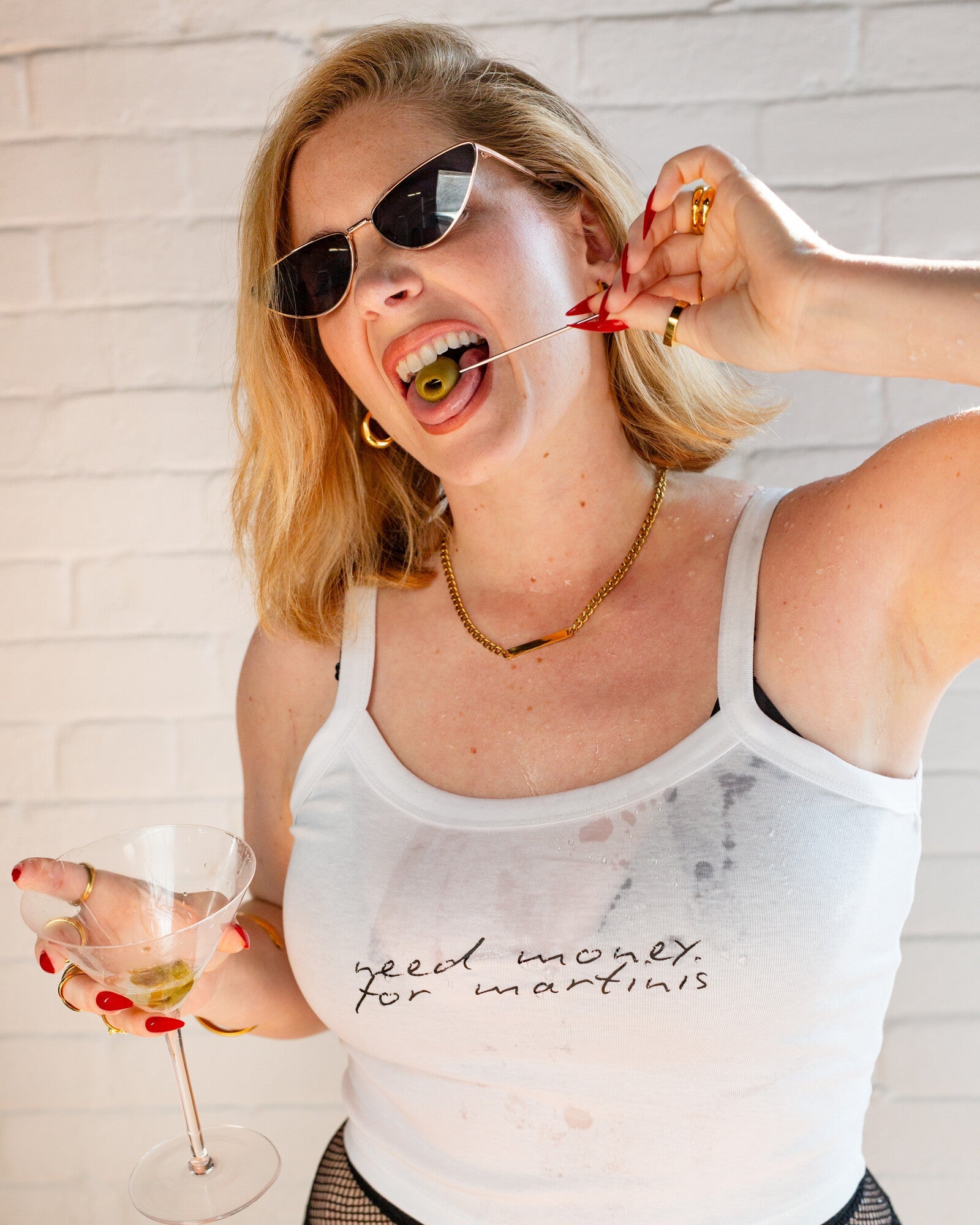 Model wearing the white Need Money for Martinis cami tank in a playful martini lifestyle photo.
