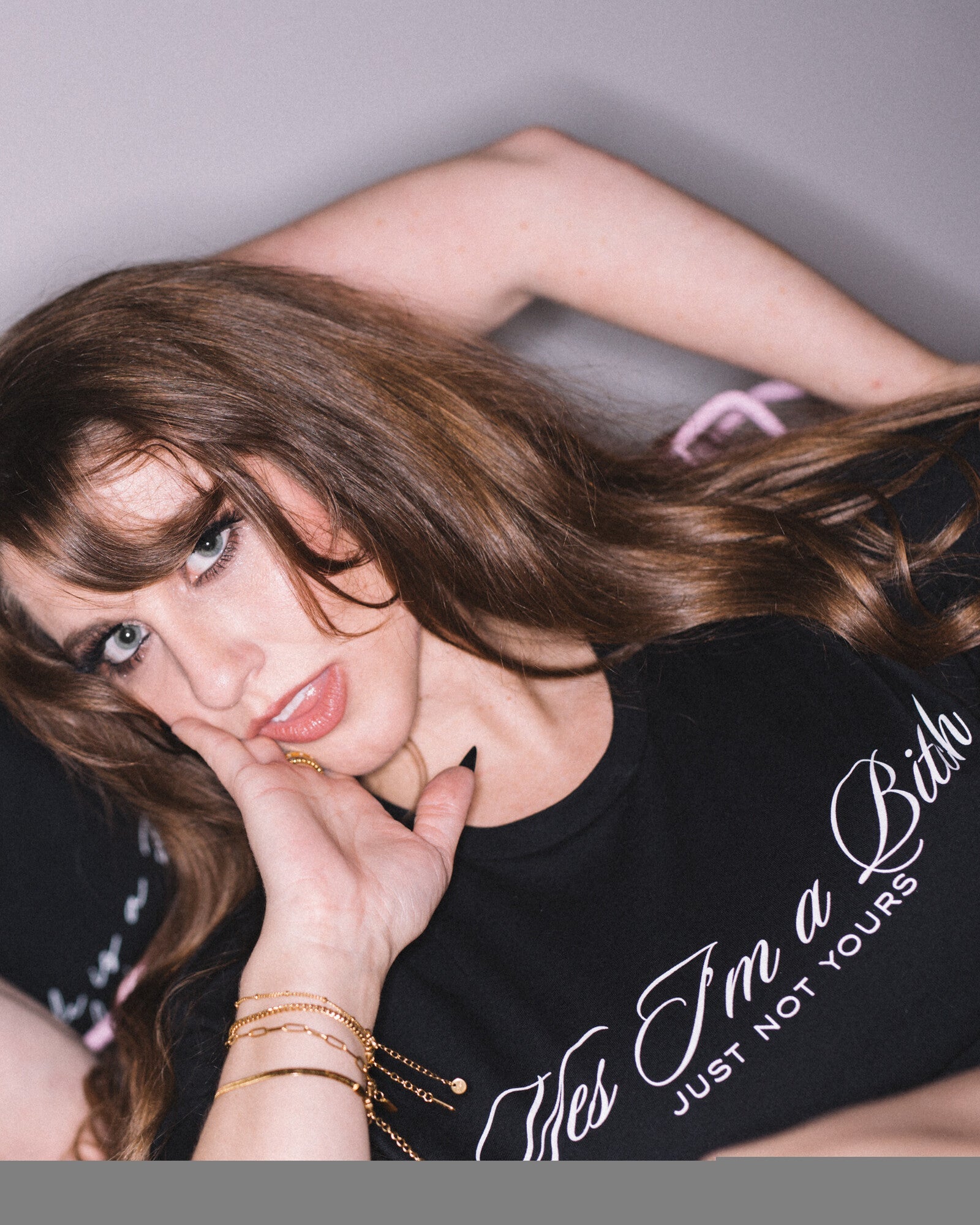 Close-up of a model wearing the black Yes I’m a Bitch — Just Not Yours cropped tee.