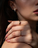 Aura gold pavé stacking ring worn in a close hand portrait.
