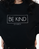 Black crewneck sweatshirt with white outlined text reading Be Kind and smaller text reading Of a Bitch.