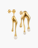 Pair of asymmetrical gold-tone sculptural earrings with white pearl-like drops.