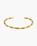 Bia Cuff, a sculptural twisted 18K Gold PVD open cuff bracelet.