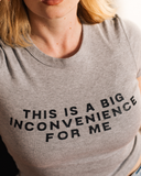 Gray baby tee reading This Is a Big Inconvenience for Me.