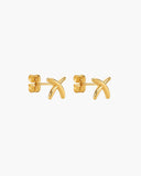 Pair of polished gold-tone crossed stake stud earrings.