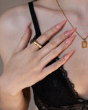 Cilla three-pearl gold statement ring worn in a tight hand detail with pale pink nails.