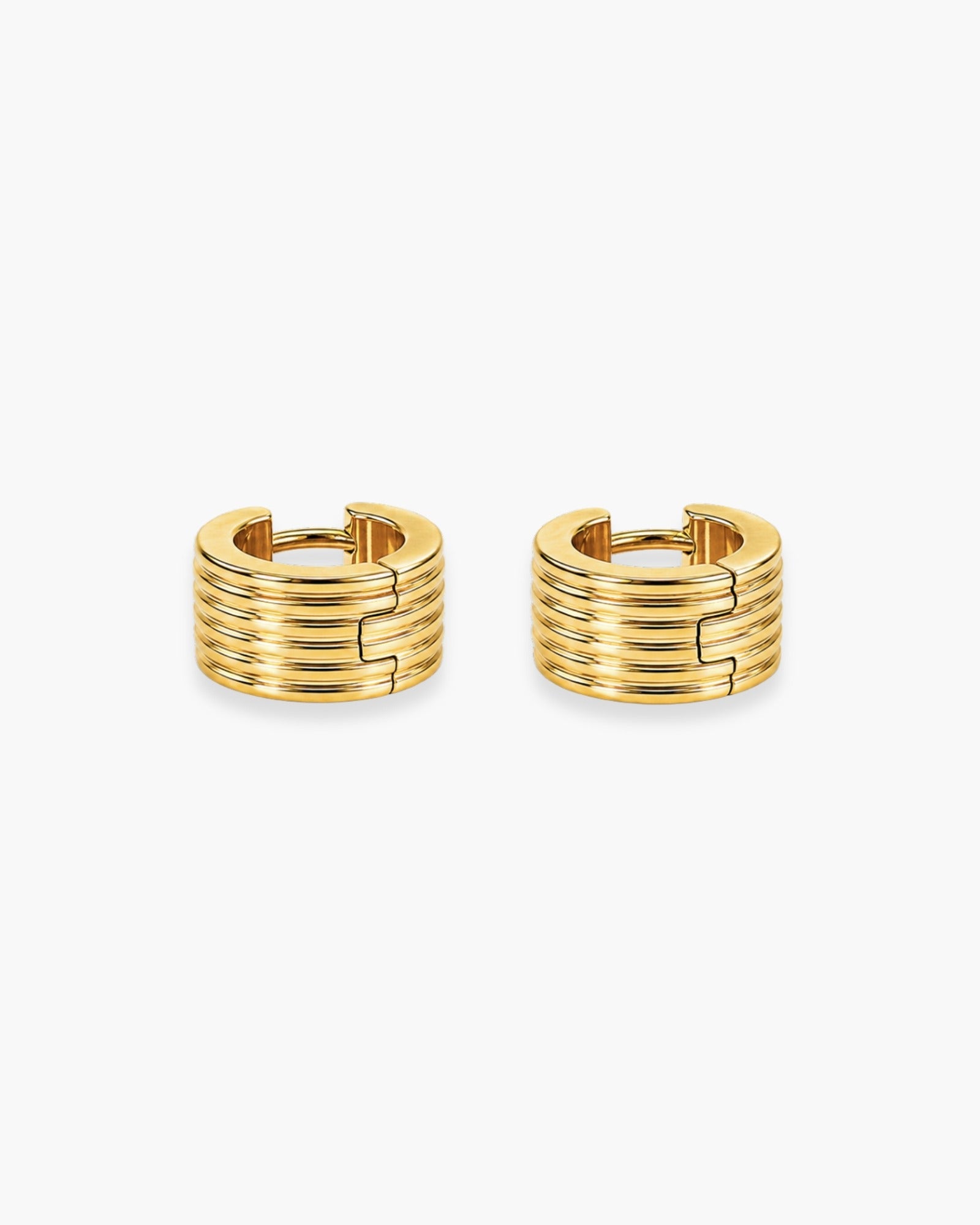 Pair of wide gold-tone huggie hoop earrings with stacked horizontal ridges.