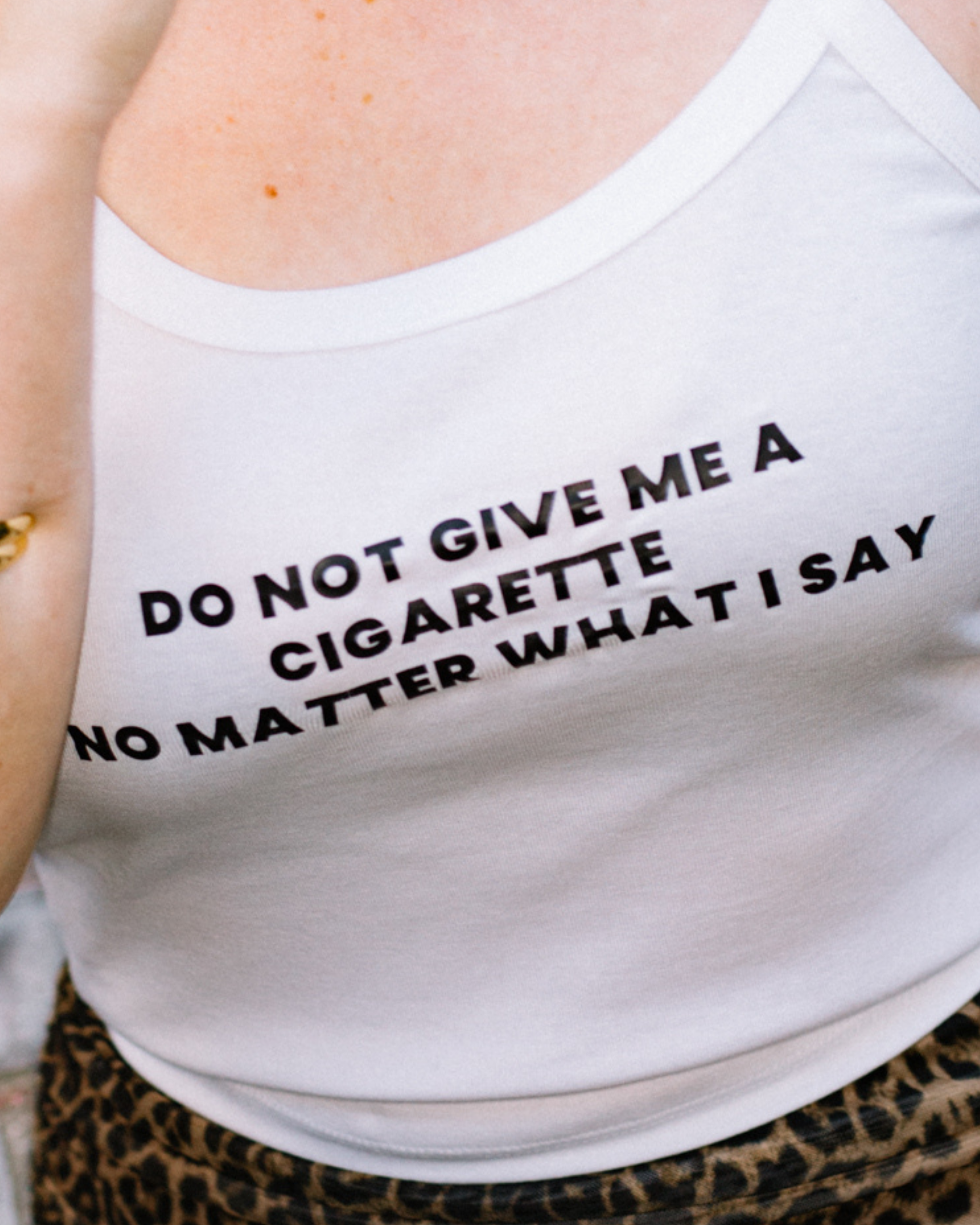 White camisole tank reading Do Not Give Me a Cigarette No Matter What I Say.