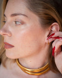 Dori curved gold threader earring worn in a tight ear detail.
