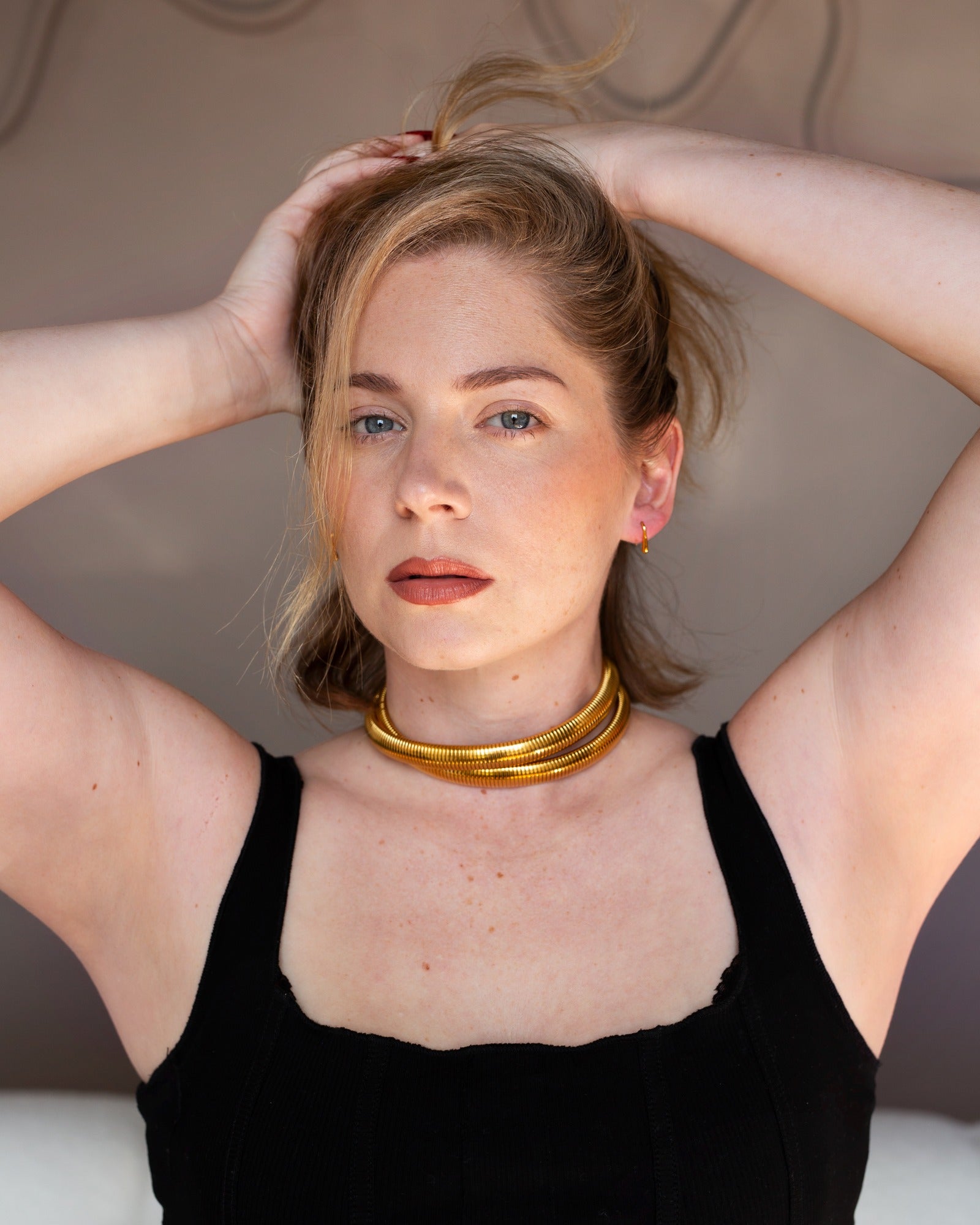 Dori curved threader earrings worn in a full fashion portrait.