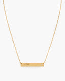 Gold-tone Fuck Bar Necklace engraved with “Fuck,” accented with one clear round stone and finished with an adjustable chain.