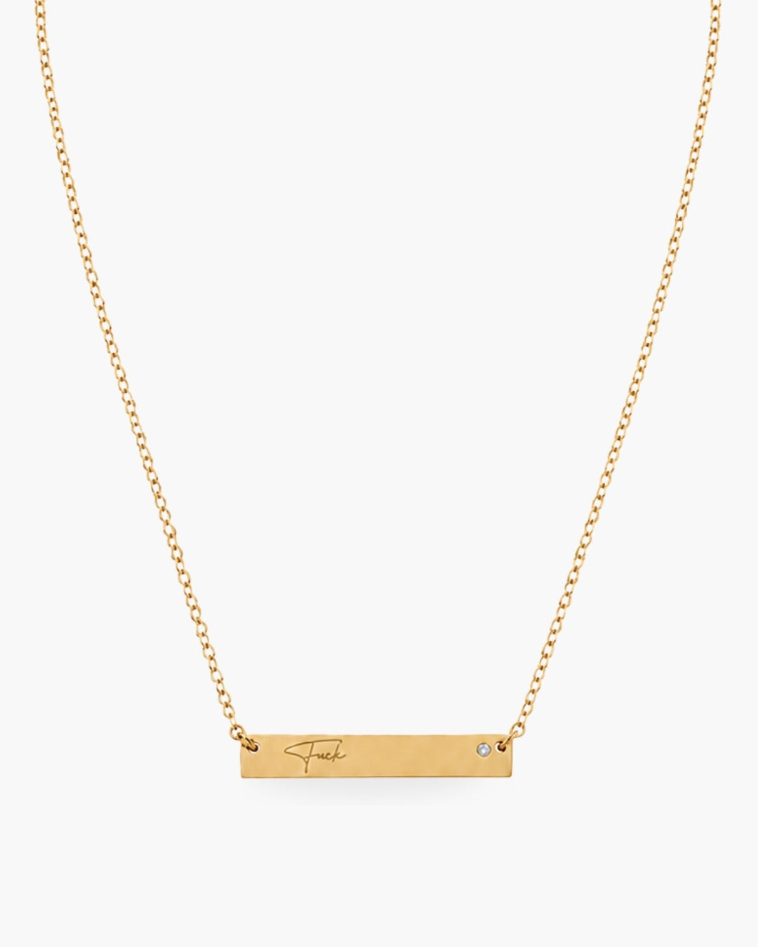 Gold-tone Fuck Bar Necklace engraved with “Fuck,” accented with one clear round stone and finished with an adjustable chain.
