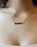 Fuck Bar Necklace worn across the neckline, hover view.