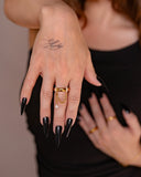 Gina crystal chain ring worn with long black nails in a tight hand detail.