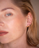 Hedy triple-row pavé ear cuff worn in a close-up portrait.