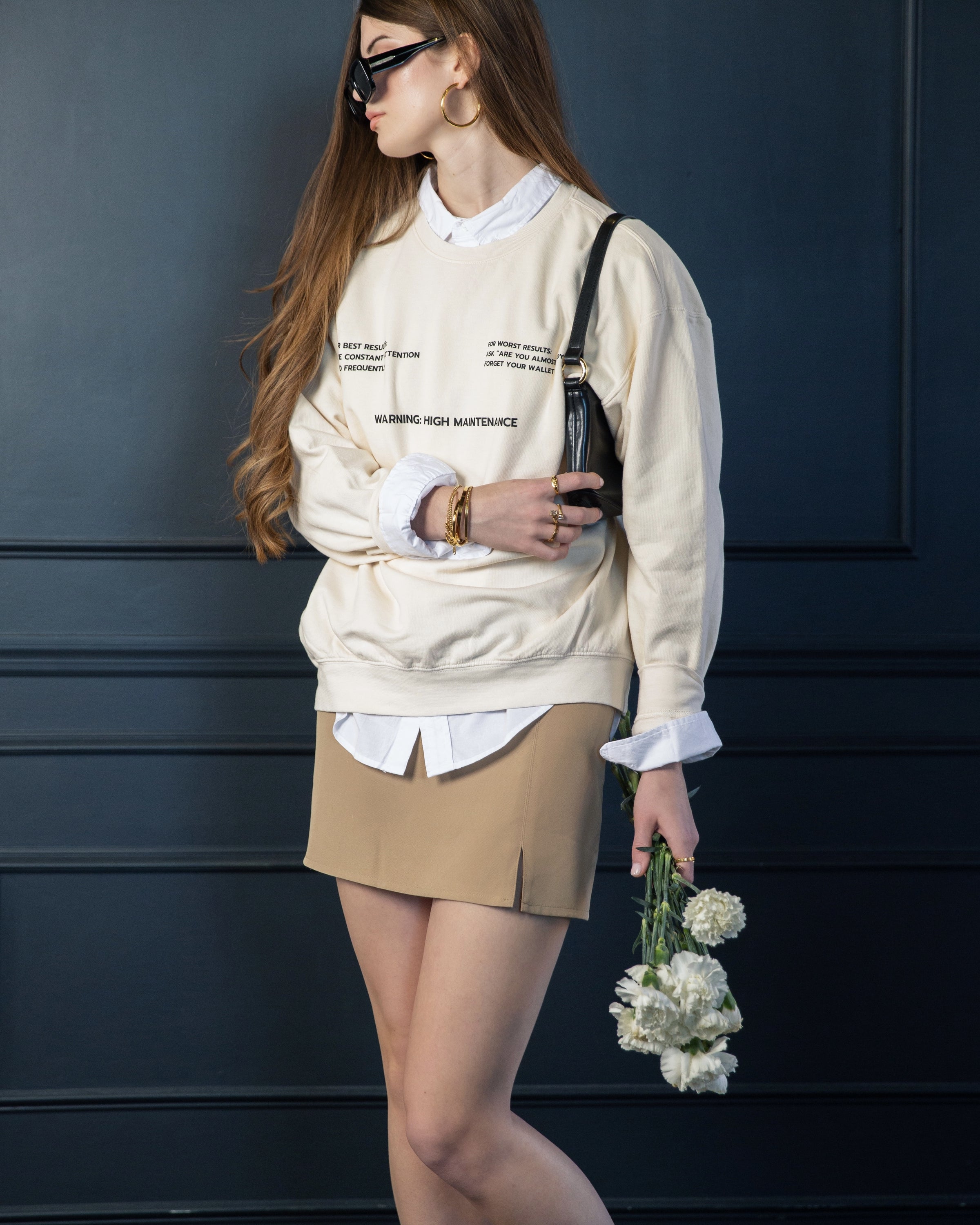 Supporting image of the cream High Maintenance crewneck sweatshirt.