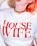 White cropped tee with red HOUSE WIFE lettering.