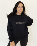 Woman wearing the black I May Be Wrong But I Doubt It crewneck sweatshirt.