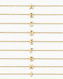 Initial Necklace letters A through I arranged on gold chains on a white background.
