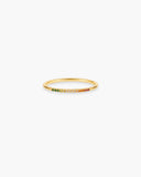 Slim gold-tone Iris stacking ring with a row of small multicolor pavé-style stones on a white background.