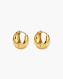 Pair of gold-tone huggie hoop earrings with a smooth tapered dome shape.