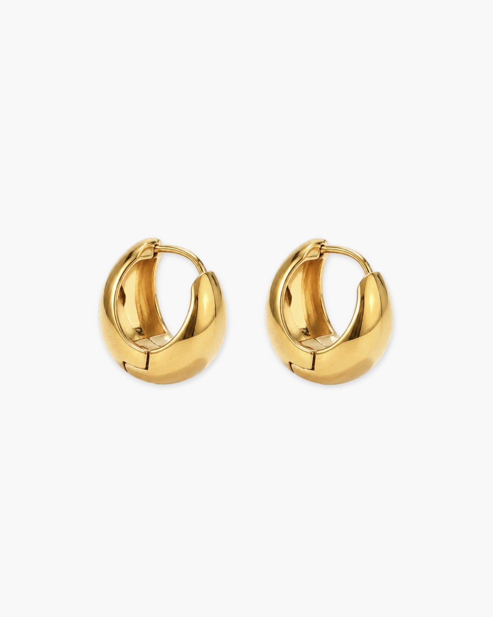 Pair of gold-tone huggie hoop earrings with a smooth tapered dome shape.