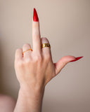 Jones geometric clear-stone ring worn on an upright hand with long red nails.