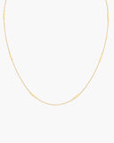 Fine gold-tone Leda Chain necklace with evenly spaced slim rectangular bar stations, a lobster clasp and adjustable extender.