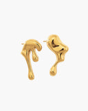 Pair of asymmetrical polished gold-tone statement earrings with sculptural molten shapes.
