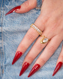 Liza emerald-cut eternity band worn with long red nails against blue denim in a tight hand detail.