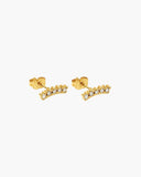 Pair of gold-tone curved stud earrings lined with clear stones.