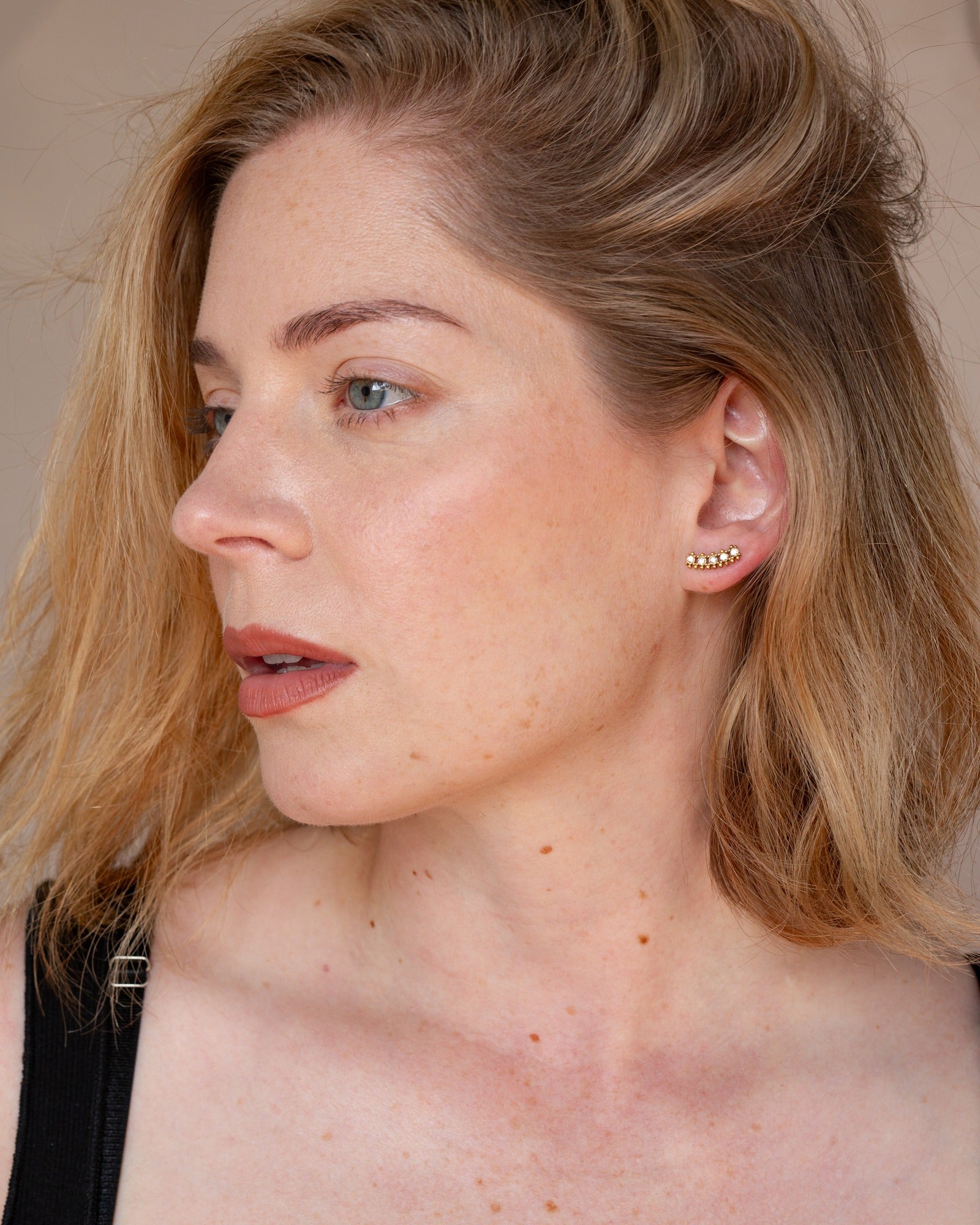Lorena curved stone stud styled in a side portrait.