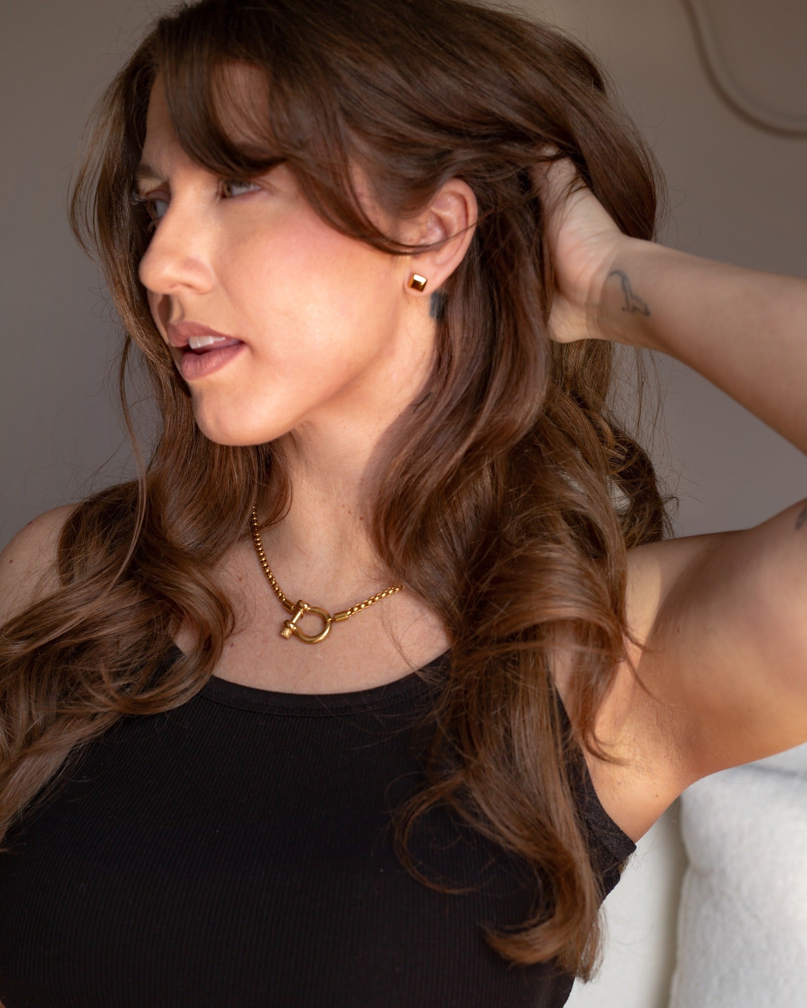 Medea polished square stud styled in a close fashion portrait.