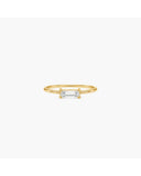 Gold-tone Nelle double-band ring with a horizontally set rectangular clear stone on a white background.