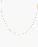 Fine gold-tone Nymph Chain necklace with a lobster clasp, adjustable extender and round end tag on a white background.