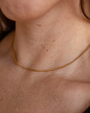 Nymph Chain worn close against the neckline, hover view.