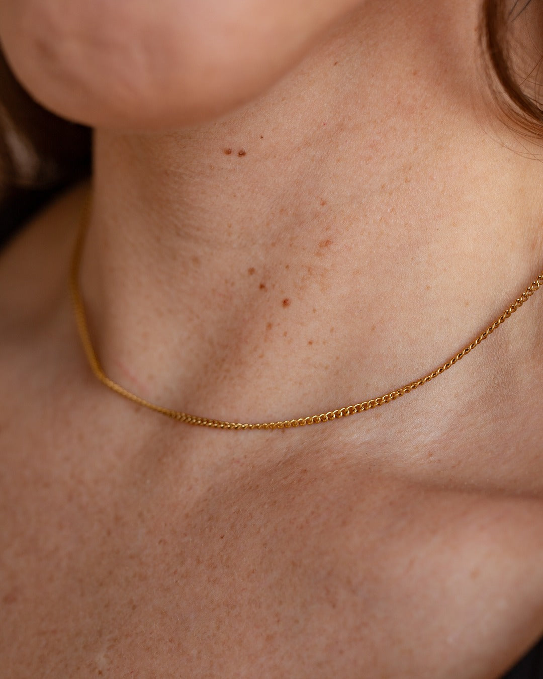 Nymph Chain worn close against the neckline, hover view.