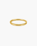 Polished gold-tone Nysa layered ring with smooth bands framing a twisted rope-texture center on a white background.