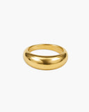 Wide polished gold-tone Octavia ring with a smooth domed band and rounded sculptural profile on a white background.