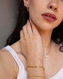 Penelope Bracelet, an 18K Gold PVD box chain bracelet with a clasp closure.