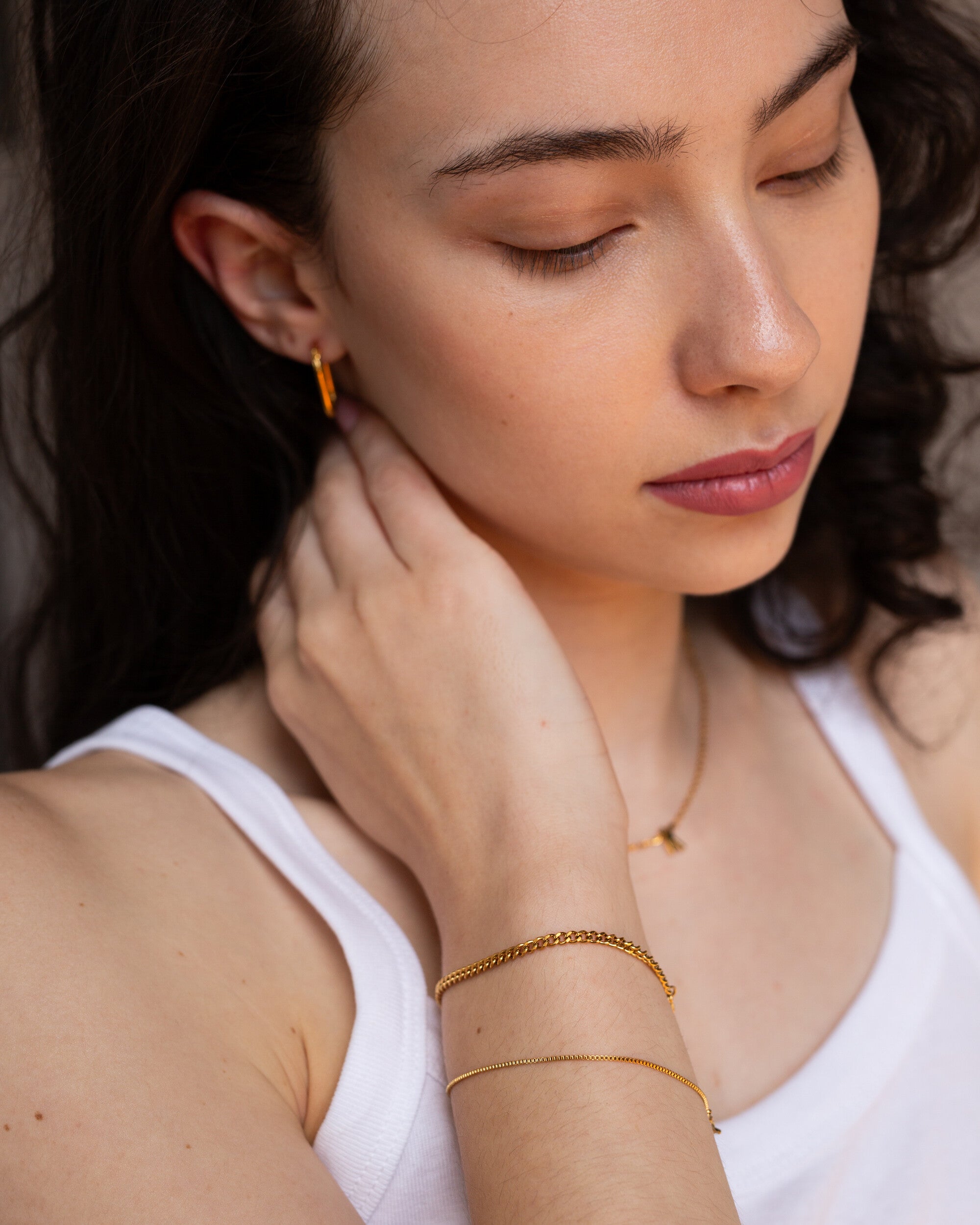 Penelope Bracelet, an 18K Gold PVD box chain bracelet with a clasp closure.