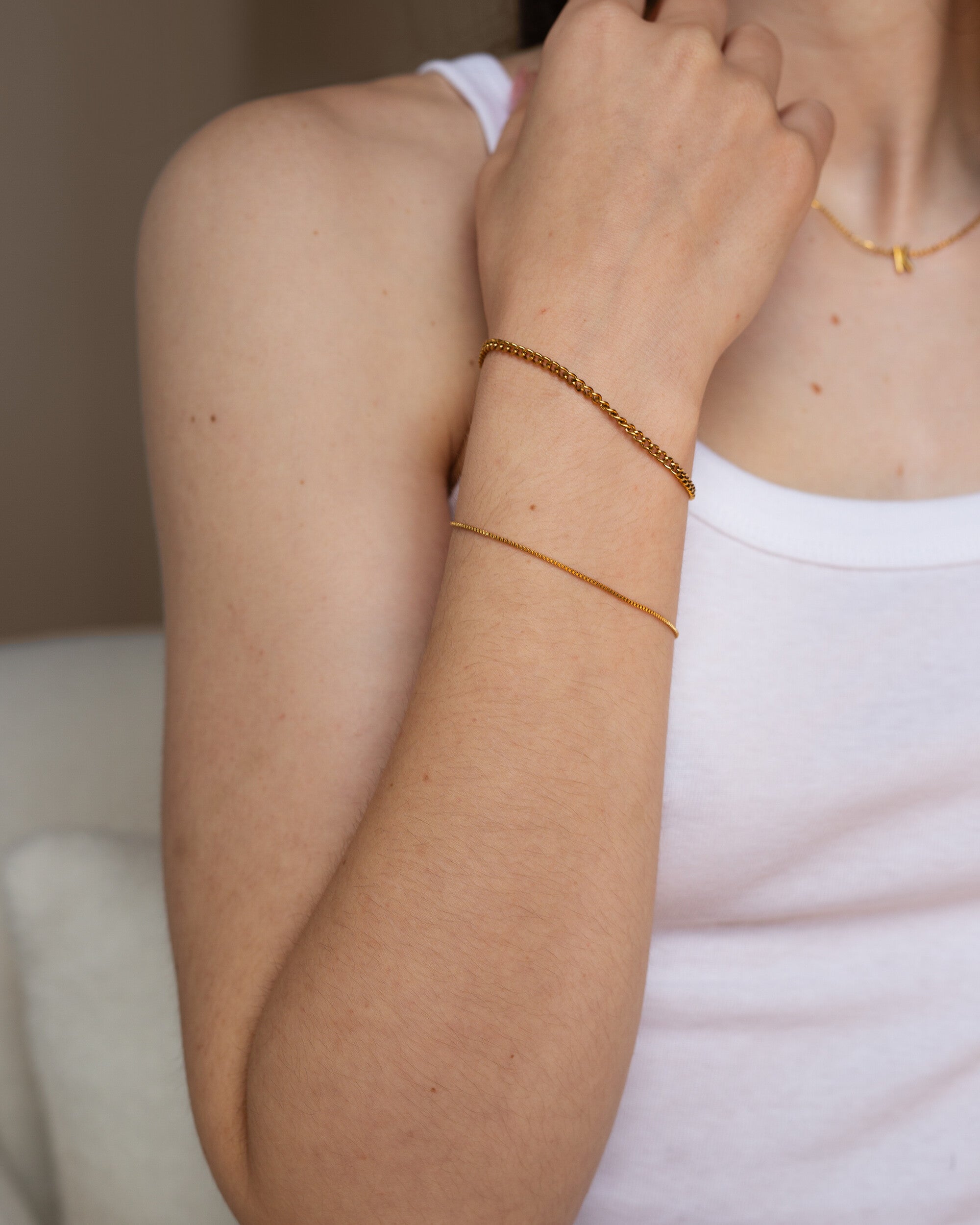 Penelope Bracelet, an 18K Gold PVD box chain bracelet with a clasp closure.