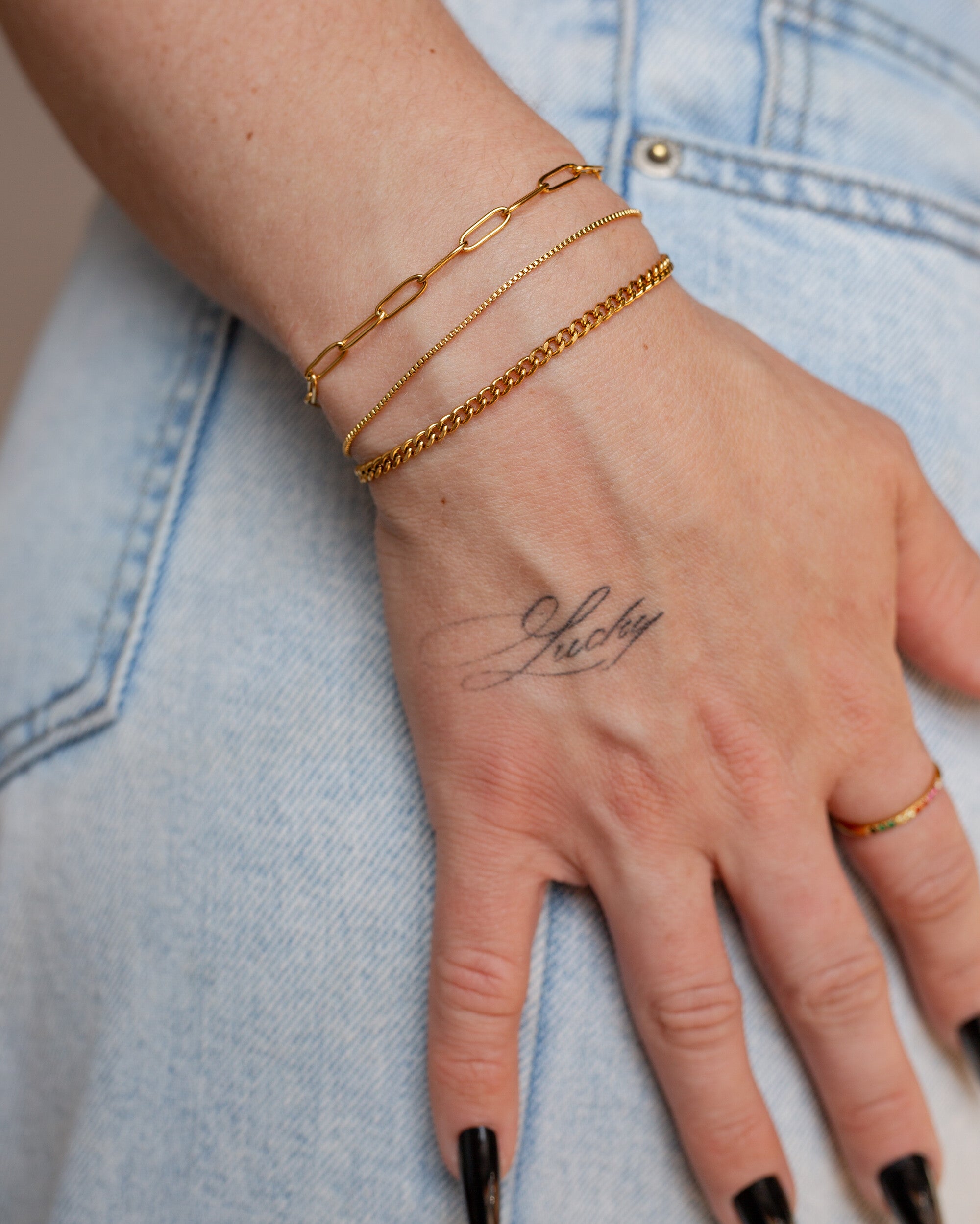 Penelope Bracelet, an 18K Gold PVD box chain bracelet with a clasp closure.