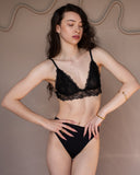 Phoebe safety-pin ring worn in a full-body fashion portrait with black lingerie.