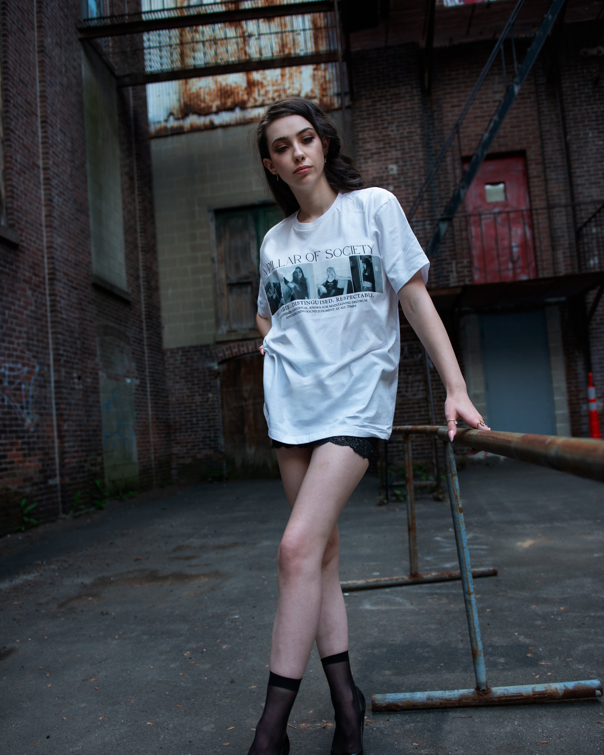 Full lifestyle view of the white Pillar of Society graphic T-shirt.
