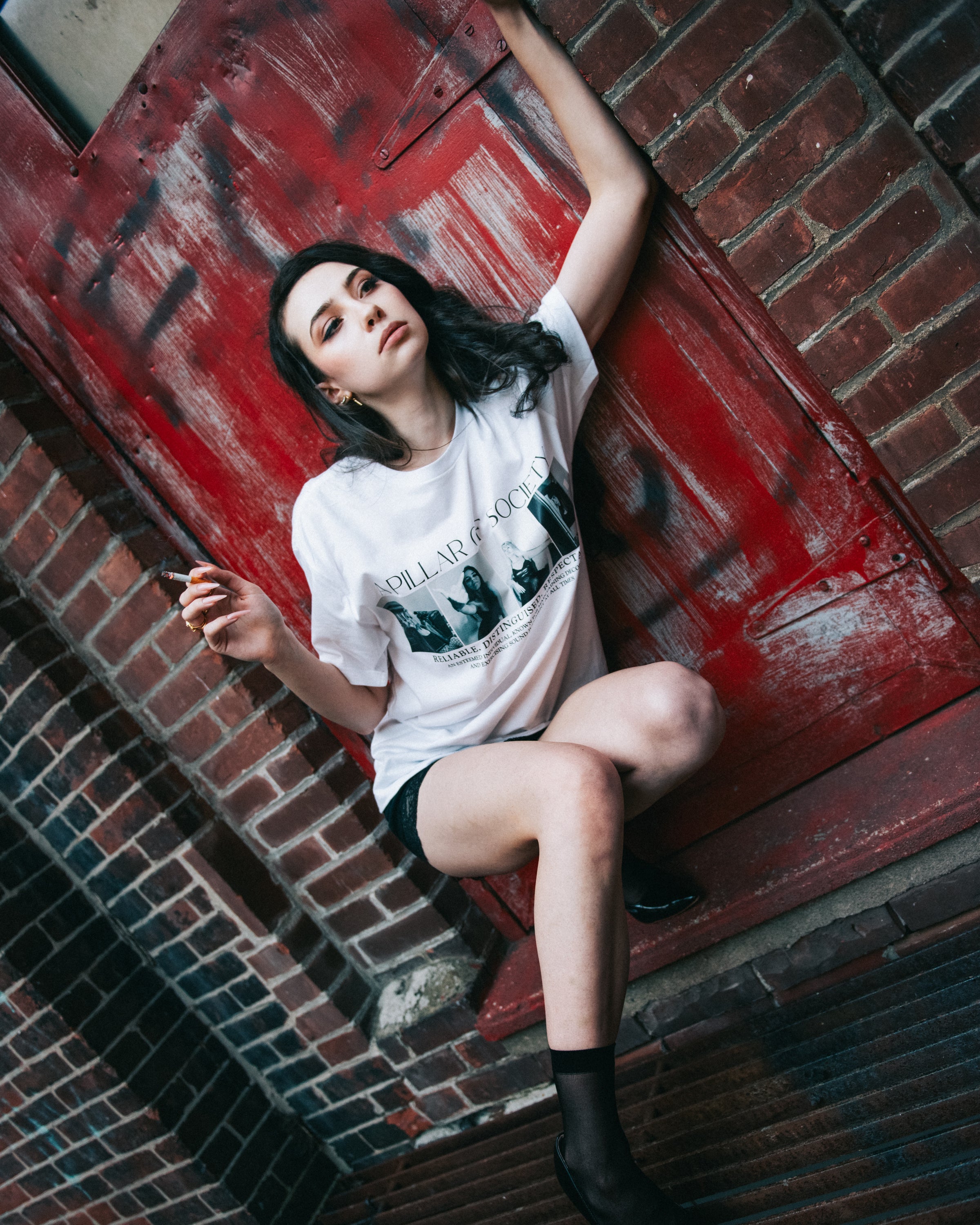 Additional lifestyle view of the white Pillar of Society graphic T-shirt.